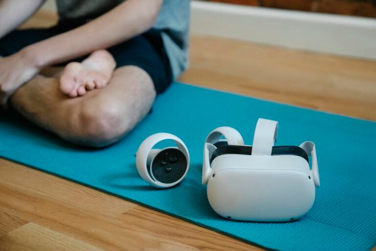 VR glasses on mat near person with crossed leg